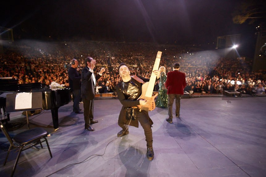 Ali Sanaei on stage facing the concert audience