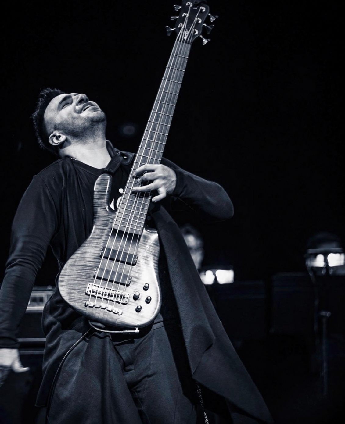 Black and white portrait of Ali Sanaei performing on bass